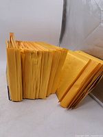 Two stacks of yellow bubble mailers