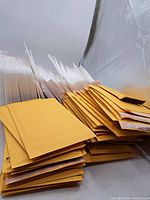 Stacks of yellow kraft and white poly bubble mailers