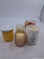 Front view of five assorted jar candles