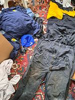 Assorted clothing spread out showing variety and condition