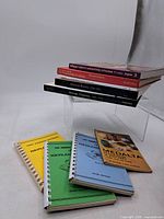 Full group of nine books showing variety of bindings and covers