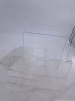 group of clear lucite risers showing size variety