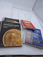 Group shot of four spiral-bound coin and currency reference books