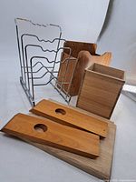 overall view showing chrome rack, wall-mount holder, wooden box, boards