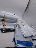 Stacks of rolled and flat plastic eBay-branded poly mailers in three bundles