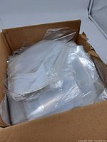 Open carton filled with stacks of clear plastic self-sealing bags