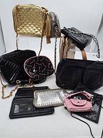 group shot of all nine purses, handbags and wallets
