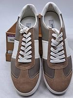 Top view of both sneakers in front of box