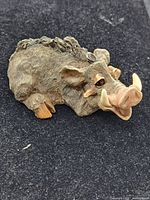 Front view of resin boar figurine showing tusks and facial detail