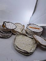 Group view of seven quilted storage cases in various sizes and prints