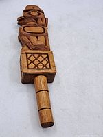 Full carving showing handle, square mid-section and upper figure