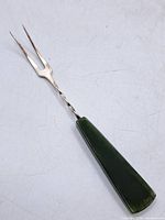 Full view of fork showing jade handle, twisted silver shaft and two tines