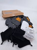 Lot overview showing velvet pouches, faux leather pouches, mailing envelopes, white small envelopes and sealed Uline bag pack