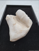 Oblique view of entire marble fragment on black tray