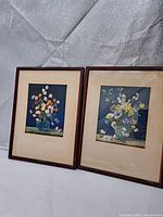 Both framed floral prints side by side showing frames and mats