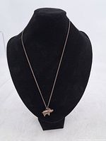 Full view of necklace displayed on bust showing chain length and pendant