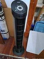 Full view of Seville Classics tower floor fan standing on base