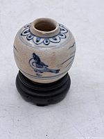 Front view of jar on stand showing bird motif and shape