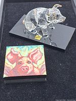 Both items together: glass pig figurine on base and mini pig painting
