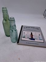 Both bottles and book together