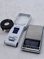 Optelec handheld magnifier, black loupe, digital scale top view