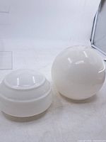 Both milk glass lampshades side by side