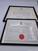 Both framed certificates side by side showing overall condition and frames