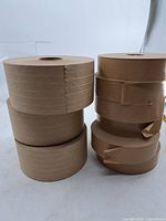 Six rolls brown reinforced tape stacked in two columns