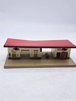 Full view of tin model station showing structure and roof