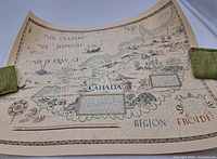 Full view of rolled vintage Canada map print held flat