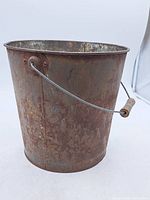 full view of rusted galvanised pail