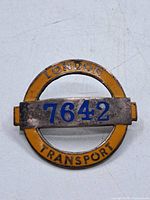 Front of badge showing London Transport text and number 7642