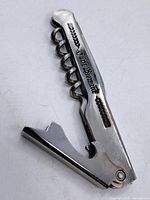 Full view of folded corkscrew showing engraving and lever