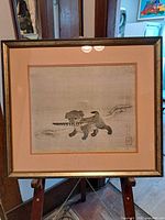 Full view of framed Chinese print on easel