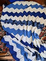 Full view of folded crochet blanket showing chevron stripes