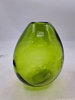 Front view of green Holmegaard Dråben vase