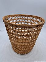 Side view of rattan wastebasket