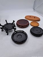 Group shot of all six wooden stands showing variety of shapes, sizes and finishes