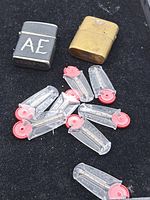 Overview of two Zippo lighters and several flint dispensers