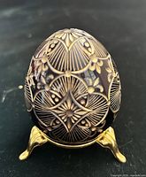 Front view of etched glass egg on stand