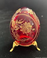 Front view of ruby red crystal egg on gold-tone stand