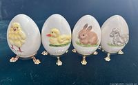 Front view four Goebel eggs showing all animal motifs and stands