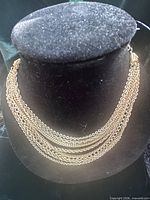 Multi-strand gold tone Coro necklace displayed on bust