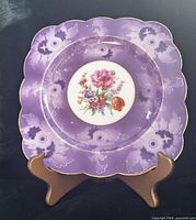 Front view of Royal Bayreuth purple lusterware square plate on stand