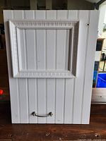 Front view of white wood message board showing framed center and handle