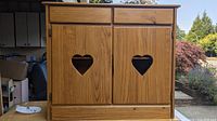 Front view of pine dresser showing two drawers and heart cutout doors