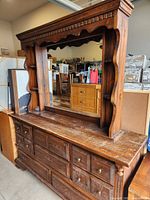 Front view of dresser with attached mirror showing overall design and drawers