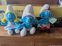 Front view of all three Smurf plush toys
