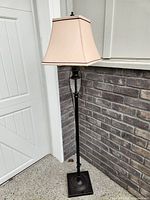 Full view of tall metal floor lamp with fabric shade