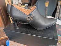 Right side view showing CK logo, heel height, overall exterior condition